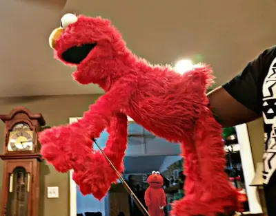 Elmo puppet hand inside meme template