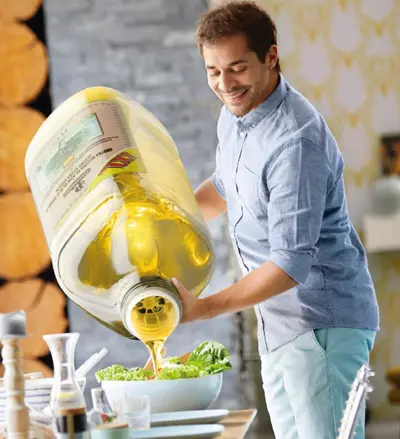 Guy pouring olive oil on the salad meme template