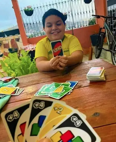 Kid holding Uno cards meme template