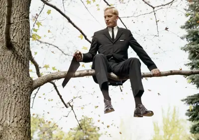 Man sawing branch sitting on meme template