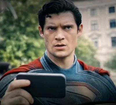 Superman looking at phone meme template